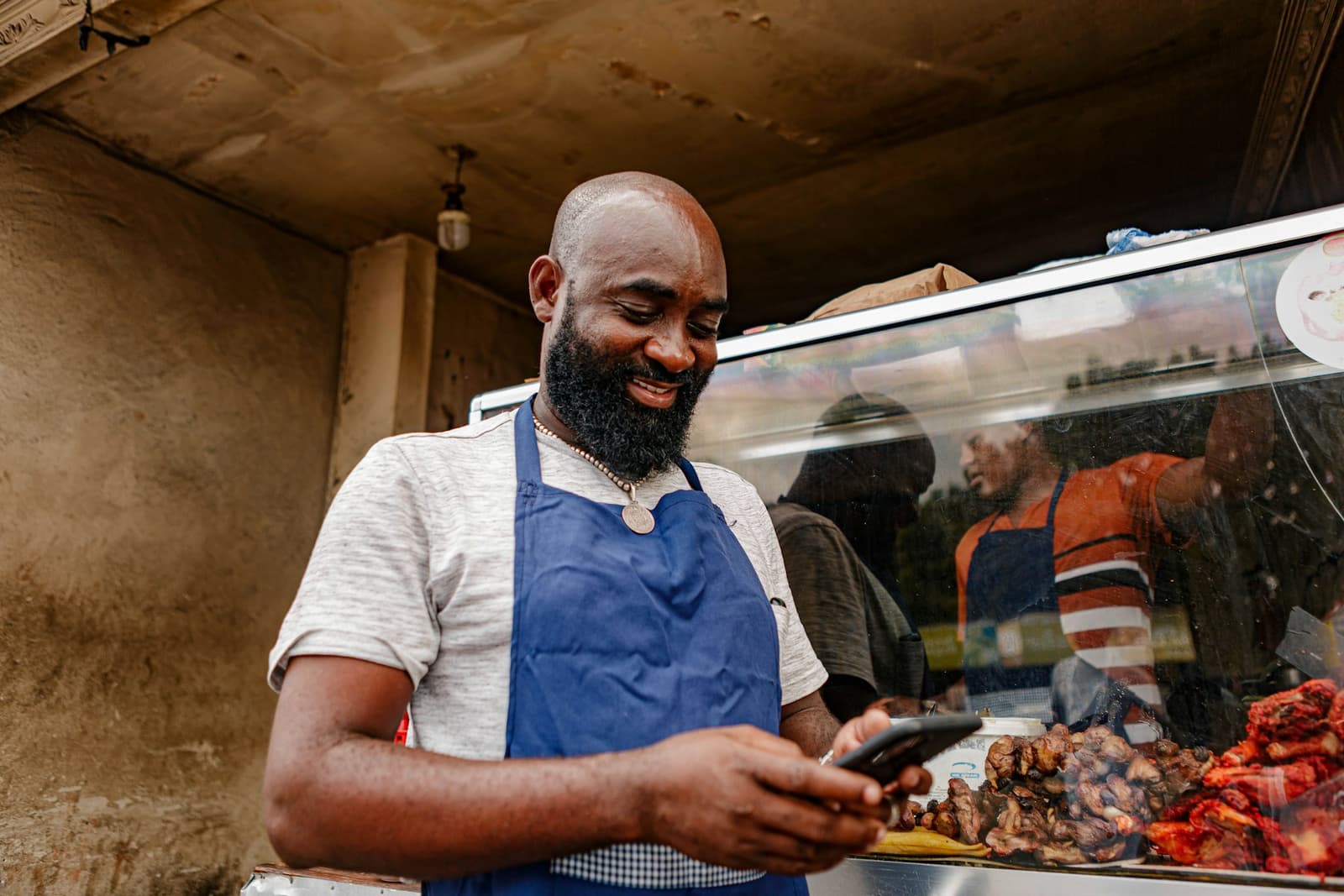 Vendor checking orders on his phone